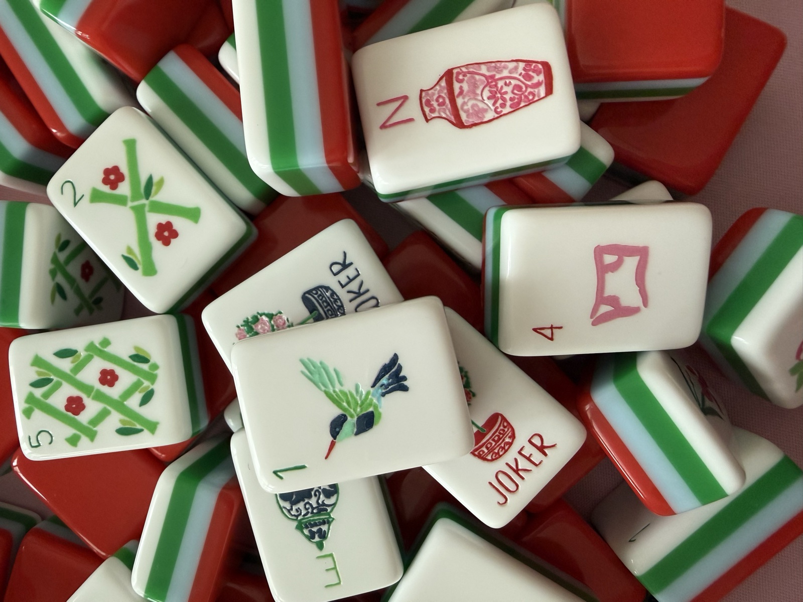 Macro closeup of the Nantucket tiles showing the teal hummingbird one-bam, red joker, pink ginger jar north wind, and green bamboo tiles
