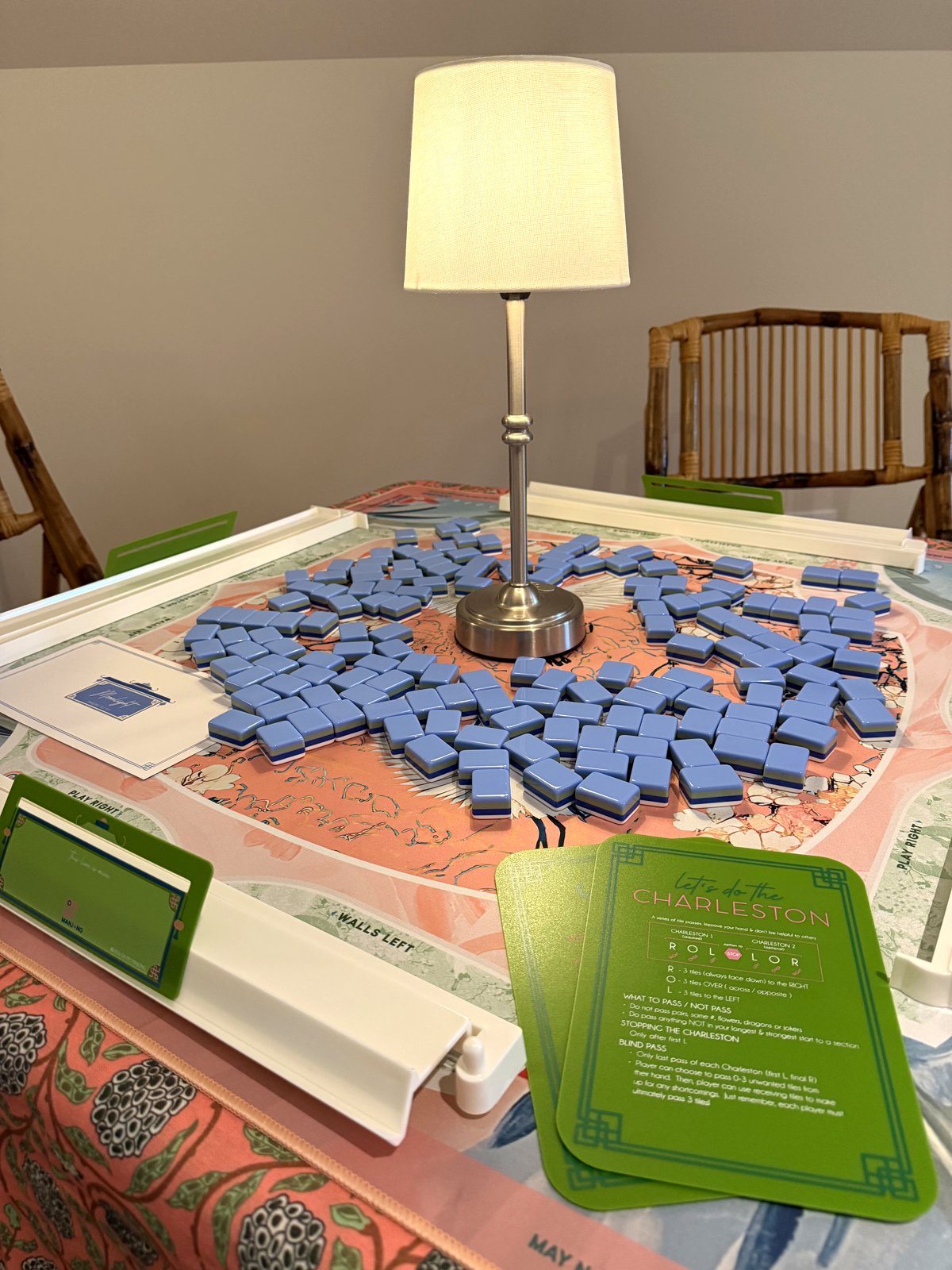 Closeup of cornflower-blue Moonlight tiles with navy edges on the coral Heron mat, beside the green 'Let's do the Charleston' reference card